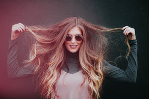 woman holding up hair with CBD