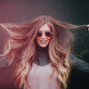 woman holding up hair with CBD
