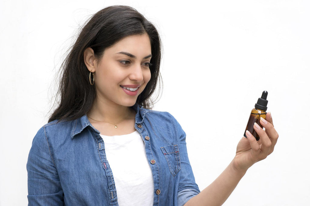 woman with CBD tincture in hand